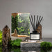 Reed diffuser with packaging on a gray background