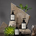 Multiple hand soap on rocks with greenery