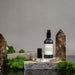 Luxury home fragrance mist displayed on stones and moss